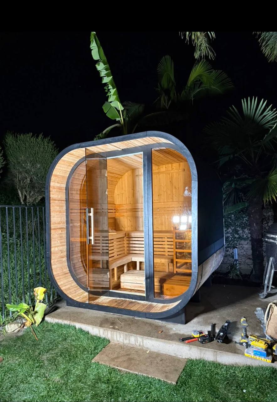 The assembled sauna photographed at night.