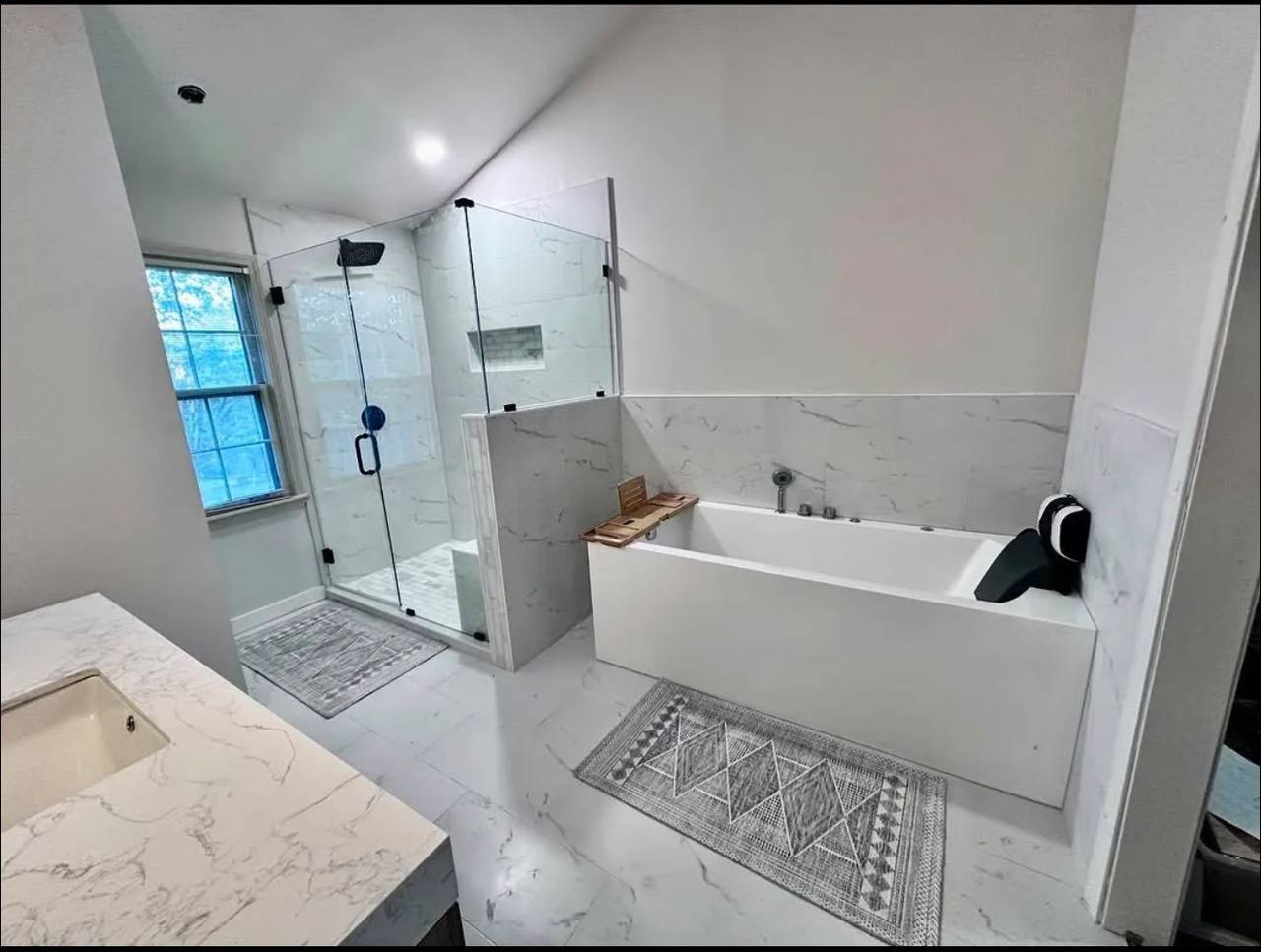 Freestanding bathtub, shower enclosure, and wall tile.
