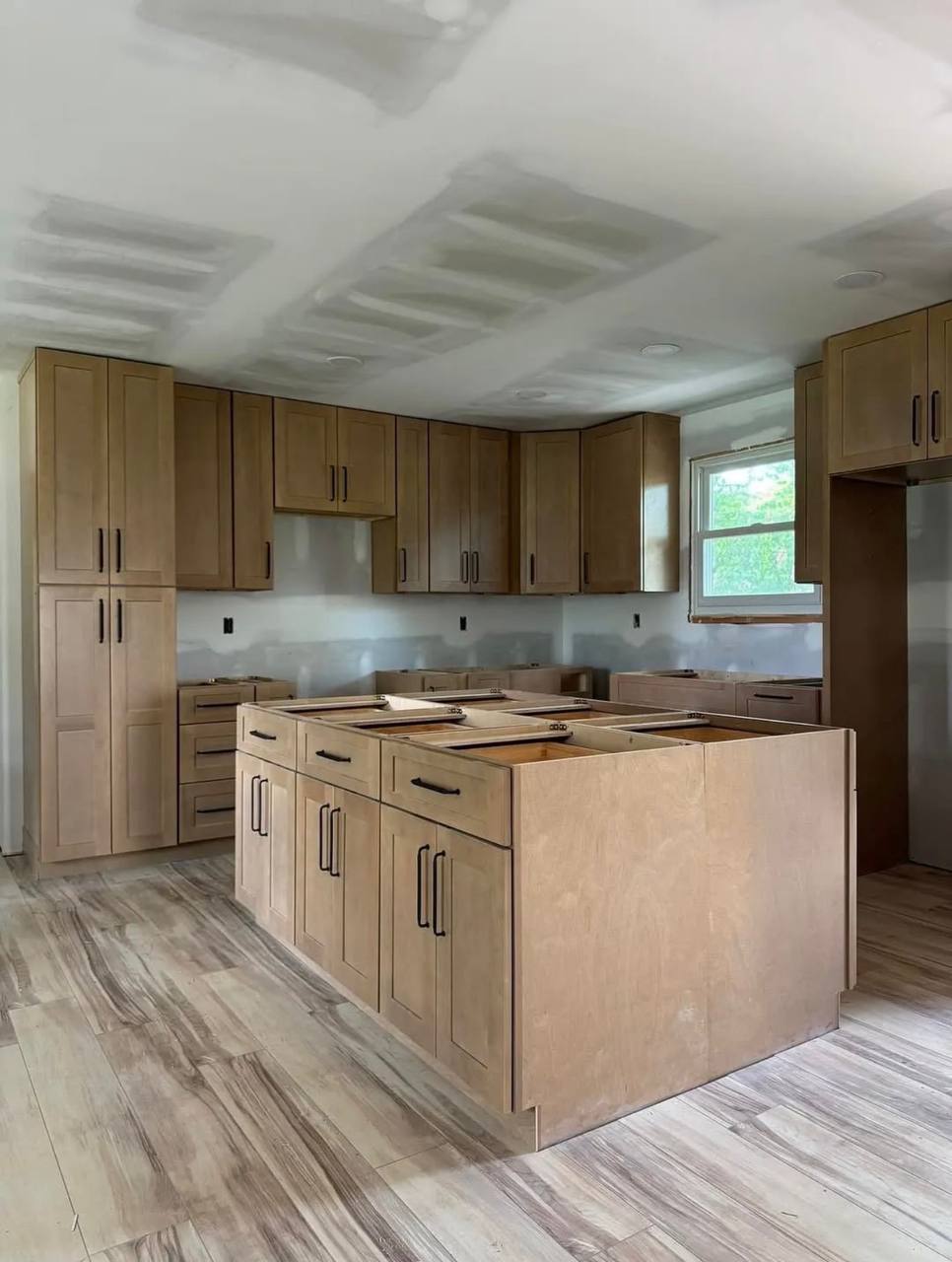 Another view of the same kitchen during cabinet installation.